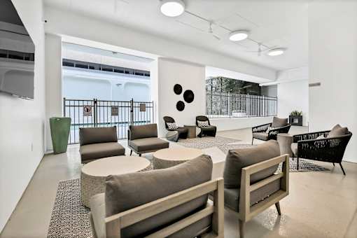 A white room with a couch, chairs, and a table at The Palms on Main, Columbia, 29201