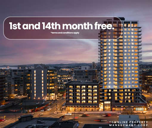 A tall building with the text "1st and 14th month free" on a banner in the foreground.