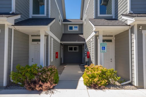 the entrance to an apartment building with a driveway at The Brix Apartments, Spokane Valley, WA, 99037