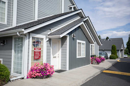 A house with a sign that says at Morning Glory Circle Apartments, Spokane, 99208