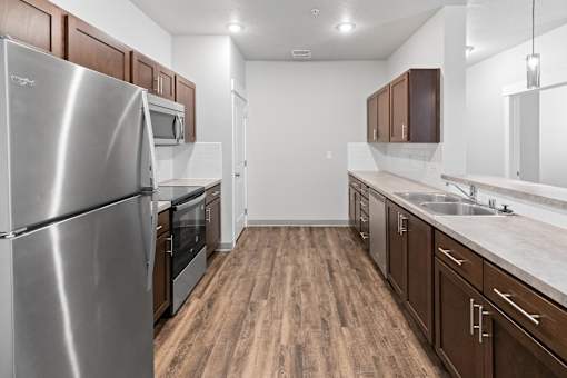 A kitchen with wooden floors and stainless steel appliances.at The Brix Apartments, Washington, 99037