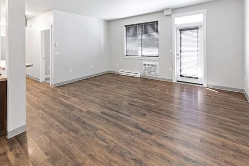 A room with wooden flooring and white walls.at The Brix Apartments, Spokane Valley, 99037