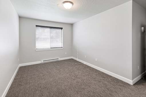 A room with a window and carpeted floor.at The Brix Apartments, Washington, 99037