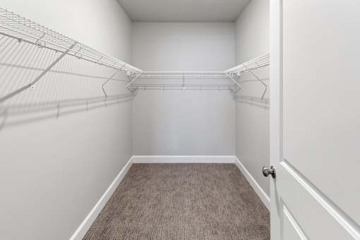A walk-in closet with a carpeted floor and white walls.at The Brix Apartments, Spokane Valley, WA, 99037
