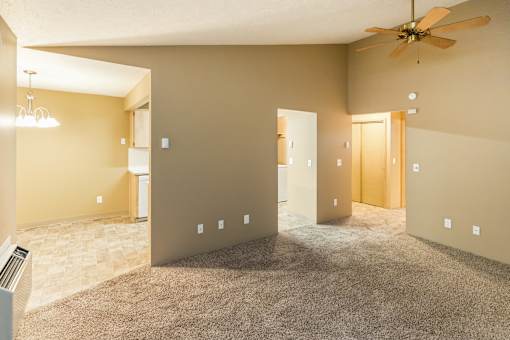A room with a ceiling fan and carpeted floor at Graymayre Crossing Apartments, Spokane, 99208