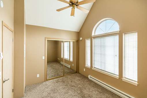 A room with a ceiling fan and a large windowat Graymayre Crossing Apartments, Spokane, WA, 99208