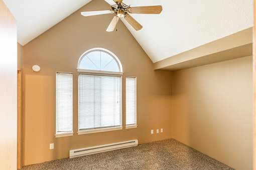 A room with a ceiling fan and a window at Graymayre Crossing Apartments, Spokane, WA, 99208