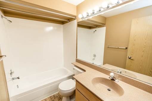 A bathroom with a white tub, toilet, and sink at Graymayre Crossing Apartments, Spokane, WA, 99208