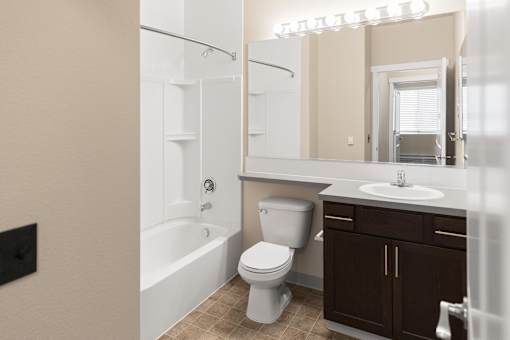A white toilet sits next to a sink in a bathroom.
