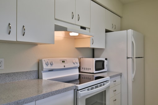Kitchen With White Cabinetry And Appliances at Charbonneau, Seattle, 98101