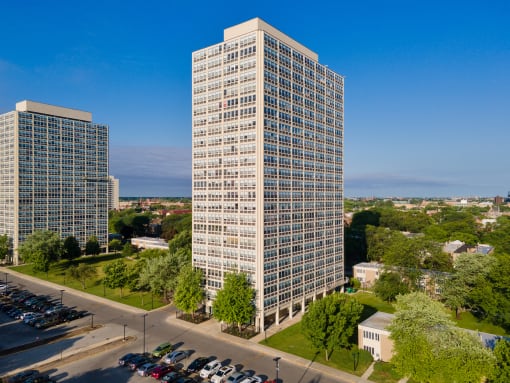 an aerial view of a tall building with two other tall buildings in the background
