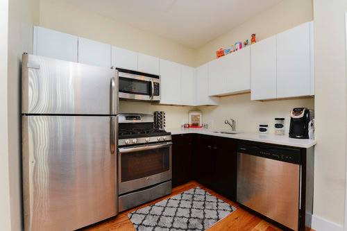 A kitchen with a stainless steel refrigerator, oven, and dishwasher.