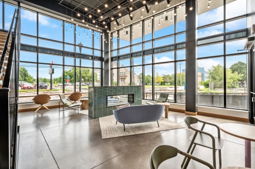 a lobby with a fireplace and large windows