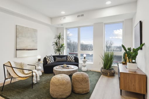 a living room with a couch and chairs and a table