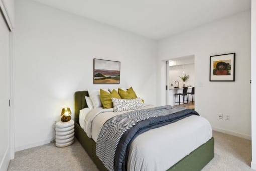 a bedroom with a large bed and white walls