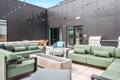 Deck with green couches and chairs and a table