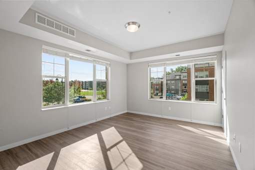 A sunny room with a view of the street outside.