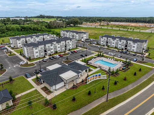 A large apartment complex with a swimming pool and a playground.