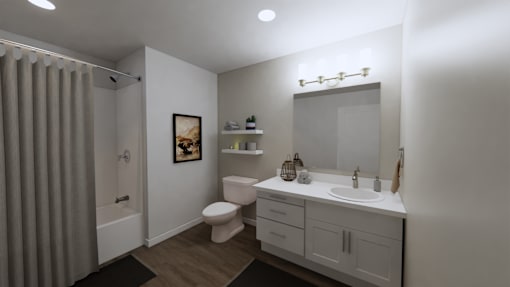 A bathroom with a toilet, sink, and shower.