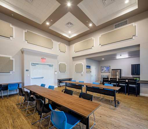 A conference room with a long table and chairs.