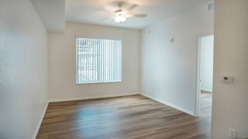 A room with a window and wooden floors.