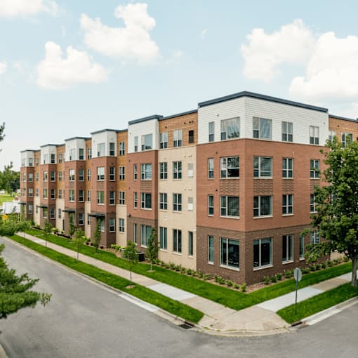 A row of modern apartment buildings with a clear sky above.