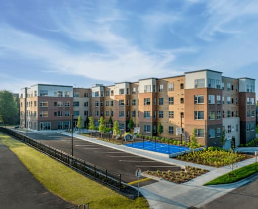 A row of modern apartment buildings with a playground in the foreground.