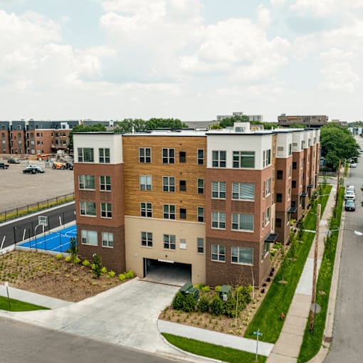 A modern apartment building with a pool in the backyard.