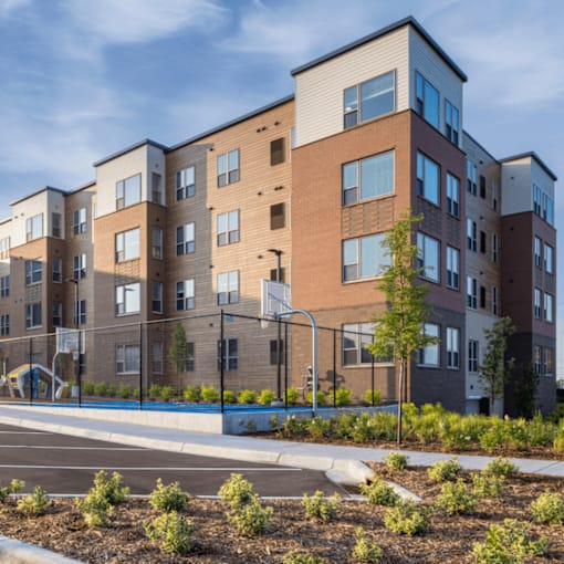 A modern apartment building with a playground in front.
