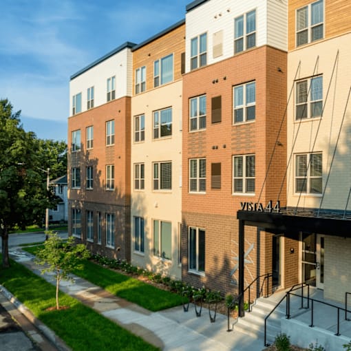 A multi-story apartment building with the name "VISTA 441" on the front.