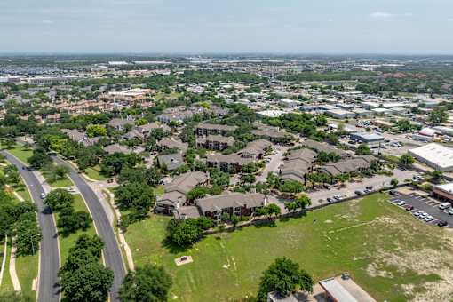 A bird's eye view of a residential area with houses and a road.
