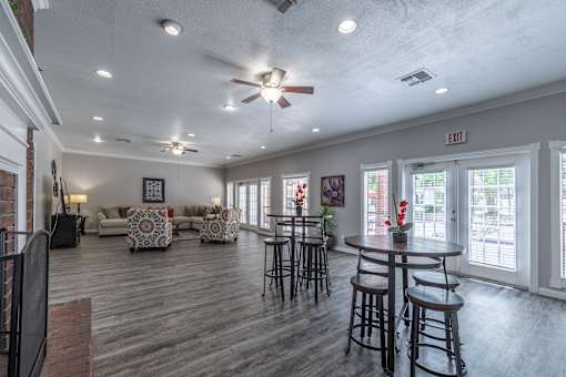 A spacious room with a ceiling fan and a couch.