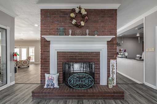 A fireplace with a sign that says "Spring" on it.