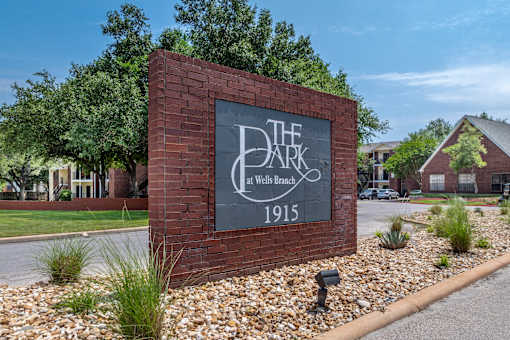A sign for The Dark at Wells Branch with the year 1915 on it.