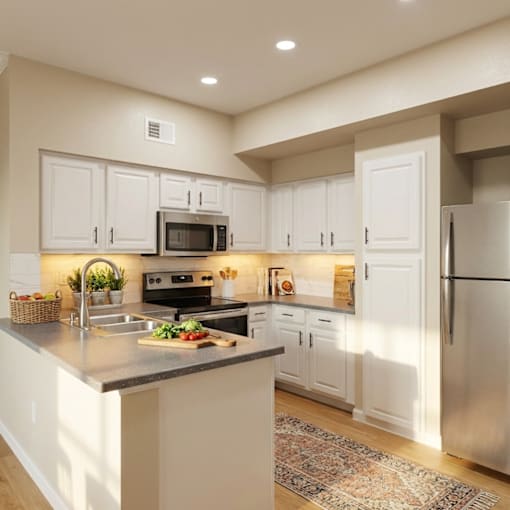 A kitchen with white cabinets and a refrigerator.
