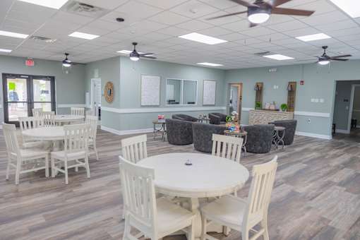 A room with a white table and chairs.