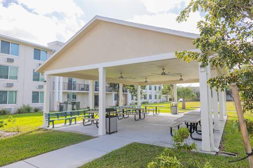 A white building with a covered patio area.