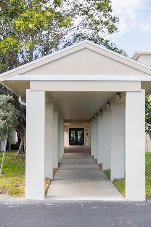 A long white covered walkway with columns on each side.