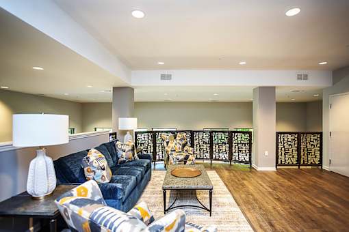 A living room with a blue couch and a coffee table.