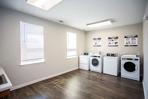 A laundry room with washers and dryers.