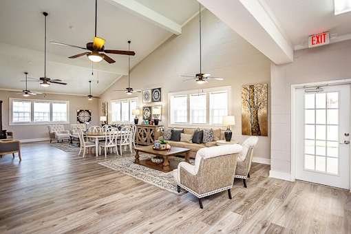 A living room with a white door and a white couch.