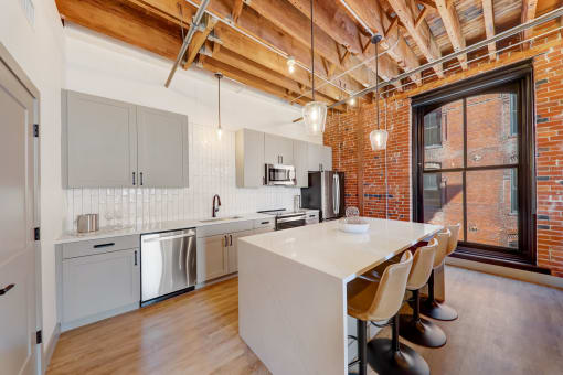 a kitchen with a white counter top and a large window