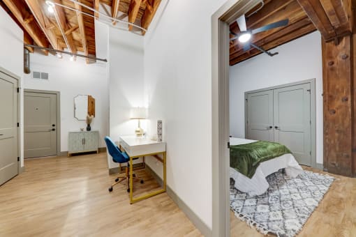 a bedroom with a bed and a desk with a chair