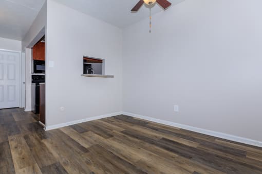 a living room with hardwood floors and a ceiling fan
