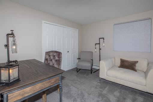 a living room with a couch and two chairs