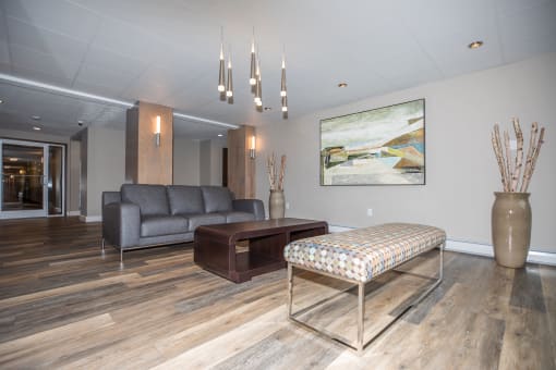 a living room with hardwood floors and grey walls