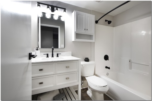 a bathroom with white cabinets at Marshall Place Apts