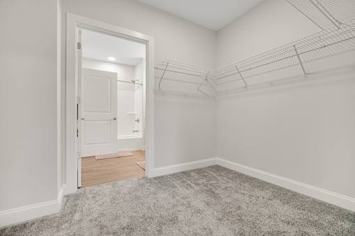 A room with a carpeted floor and a doorway leading to another room. at Park Lamont Townhomes Apartments, Cleveland