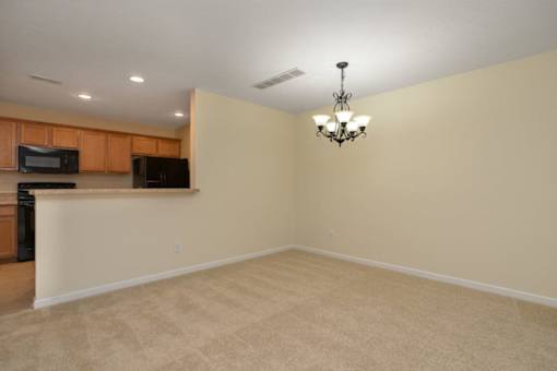 A room with a chandelier and a counter.