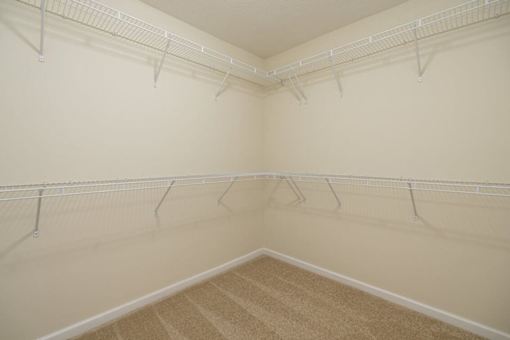 Empty room with white walls and a carpeted floor.